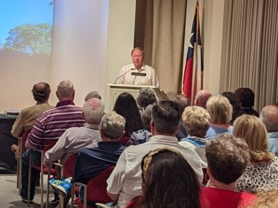 William “Bill” Wilson, the great-grandson of W.P.H. and Ida McFaddin (the original occupants of what is now the McFaddin-Ward House Museum), speaks to a packed house during the McFaddin-Ward House Lecture Series event on Sept. 15.